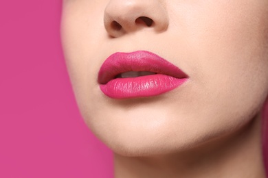 Photo of Beautiful young woman with perfect lips makeup on color background, closeup