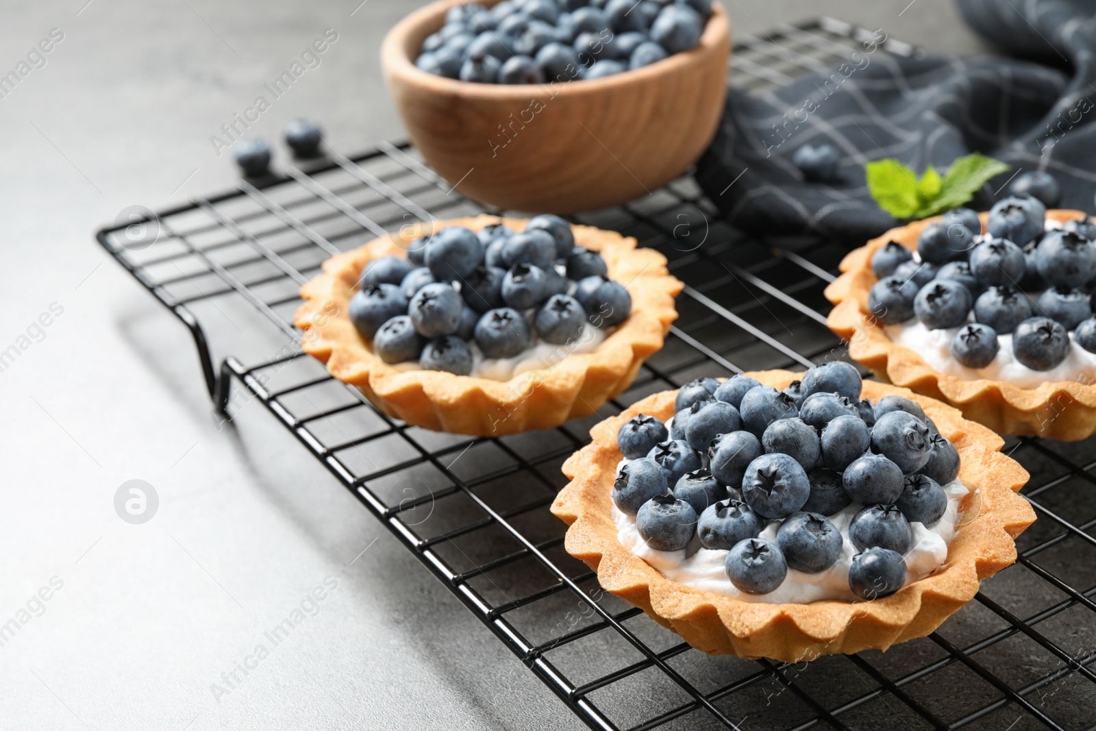 Photo of Delicious sweet pastry with berries on grey table