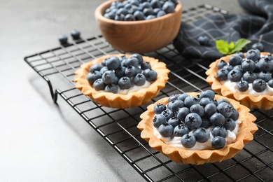 Delicious sweet pastry with berries on grey table