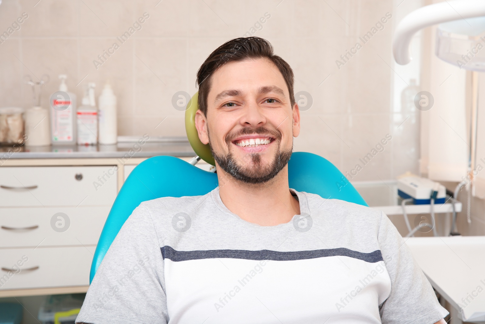 Photo of Happy man having dentist's appointment in modern clinic