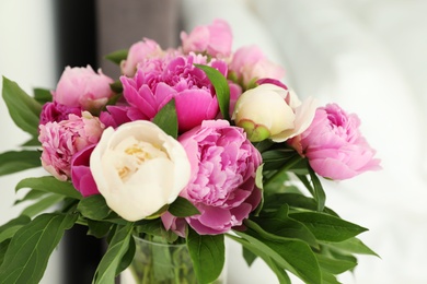 Photo of Bouquet of beautiful peonies on blurred background, closeup