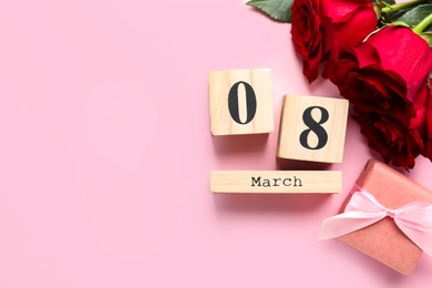 Photo of Date 8th of March, roses and gift box on pink background, flat lay with space for text. International Women's Day