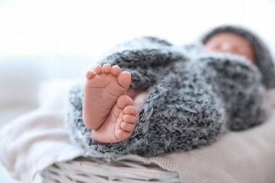 Newborn baby lying on plaid, closeup of legs