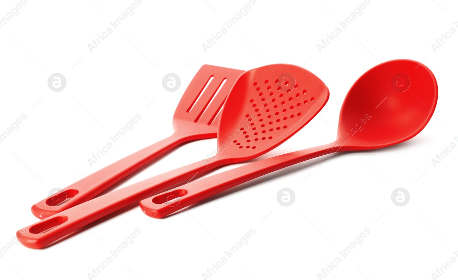 Photo of Different colorful kitchen utensils on white background