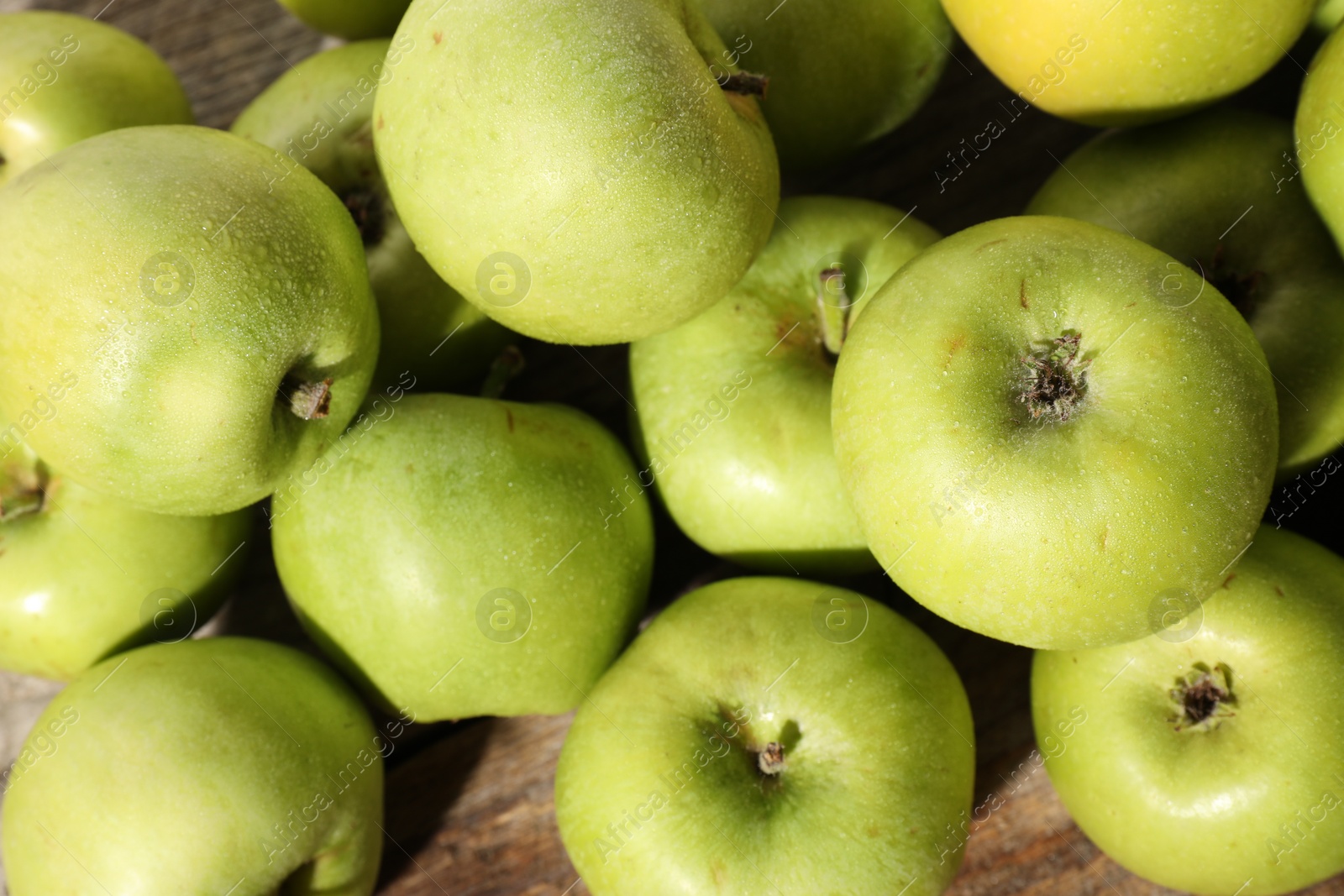 Photo of Many fresh apples on wooden table, top view