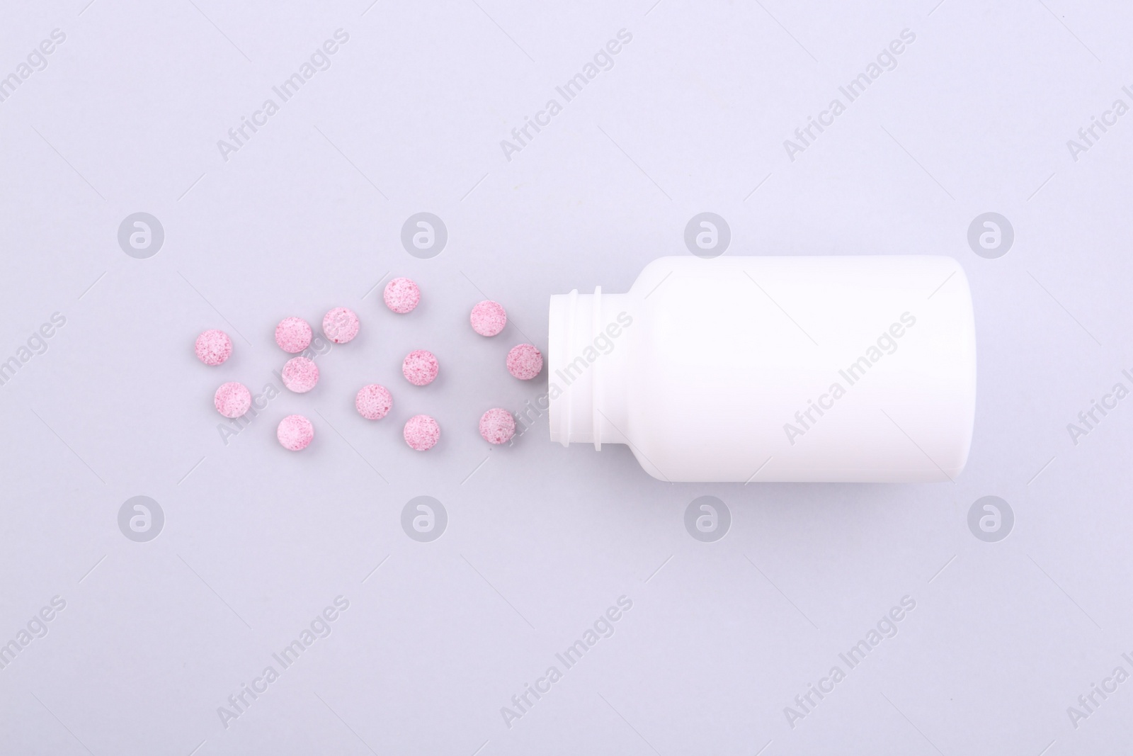 Photo of Jar with vitamin pills on white background, top view