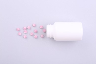 Photo of Jar with vitamin pills on white background, top view