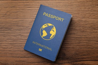 Image of Blue international passport on wooden table, top view