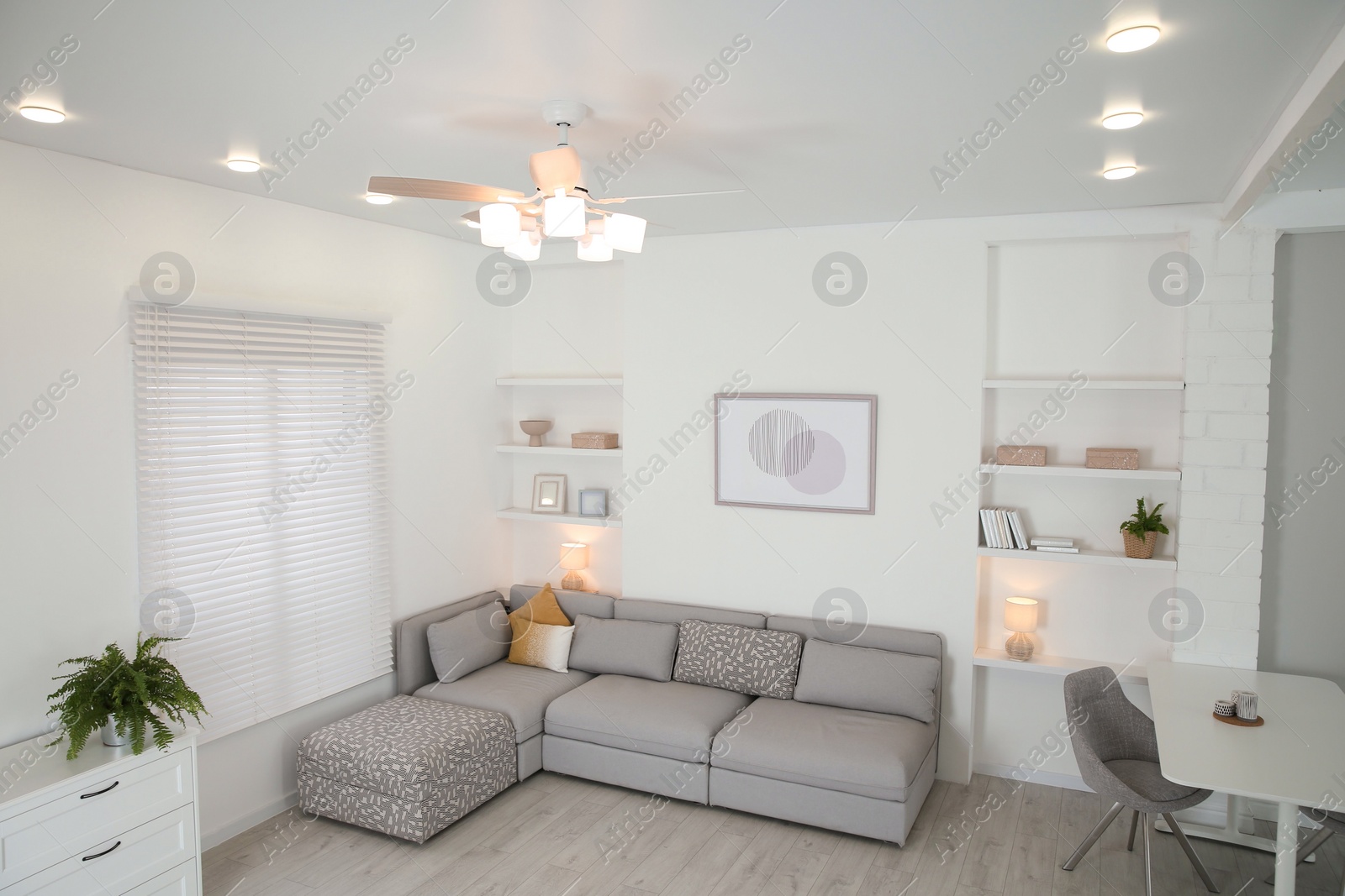 Photo of Ceiling fan, furniture and accessories in stylish living room, above view