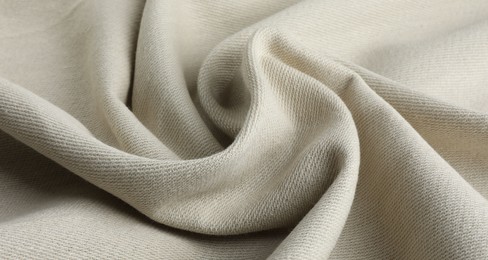 Texture of beige crumpled fabric as background, closeup