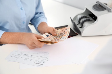 Photo of Female teller with money at cash department