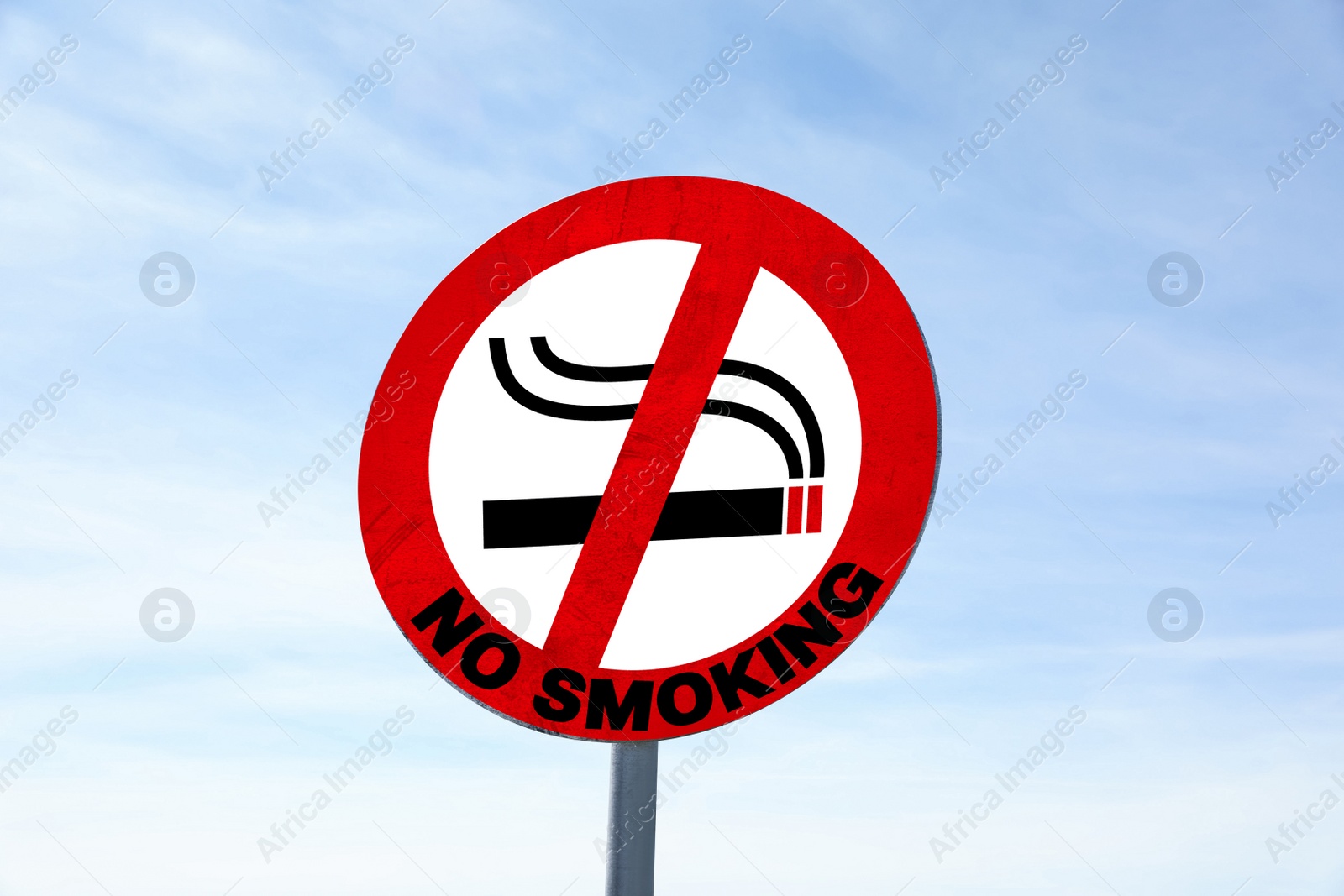 Image of Sign No Smoking outdoors against blue sky