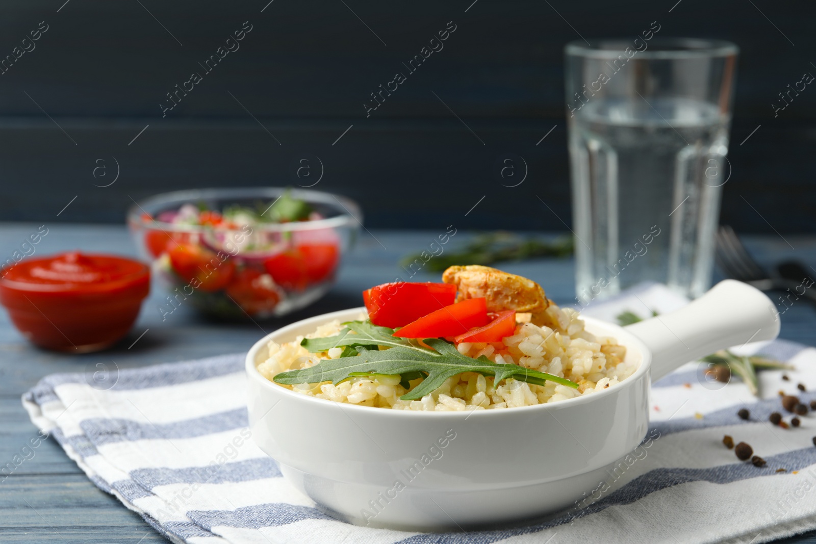 Photo of Delicious chicken risotto served in bowl on table