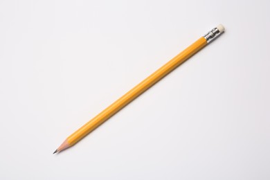 Sharp graphite pencil on white background, top view