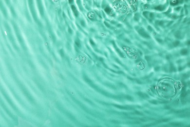 Photo of Closeup view of water with rippled surface on light blue background