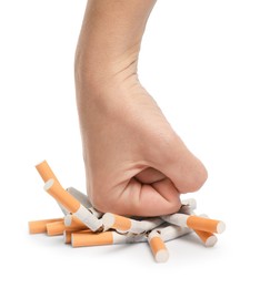 Photo of Stop smoking. Man crushing cigarettes on white background, closeup