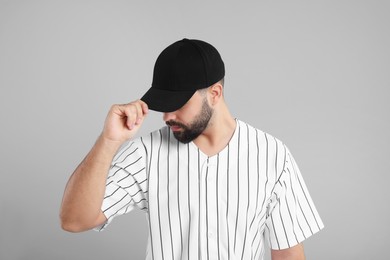 Photo of Man in stylish black baseball cap on light grey background