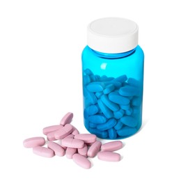 Photo of Bottle and pile of vitamin pills isolated on white