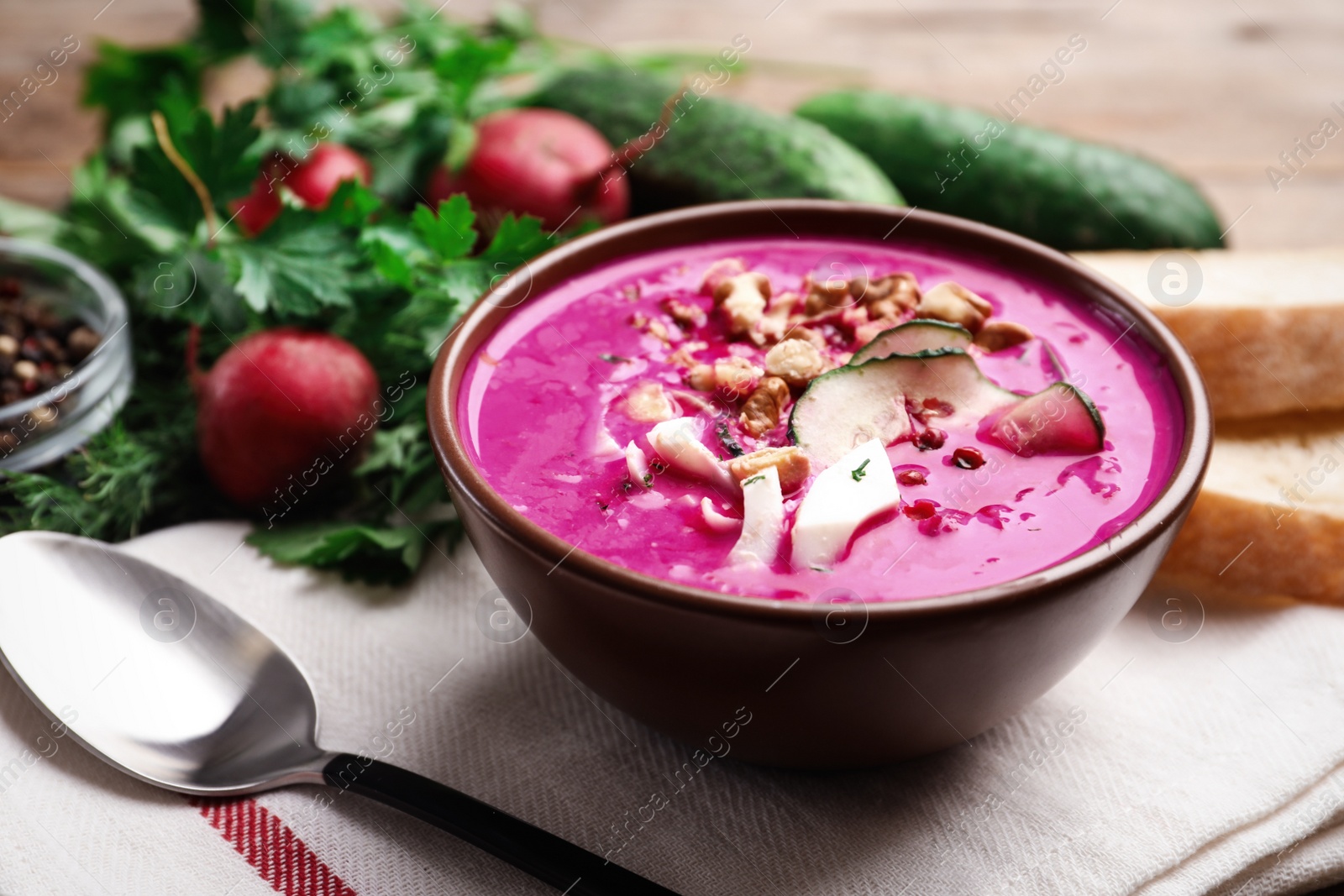 Photo of Delicious cold summer beet soup on table