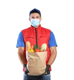 Photo of Courier in medical mask holding paper bag with food on white background. Delivery service during quarantine due to Covid-19 outbreak