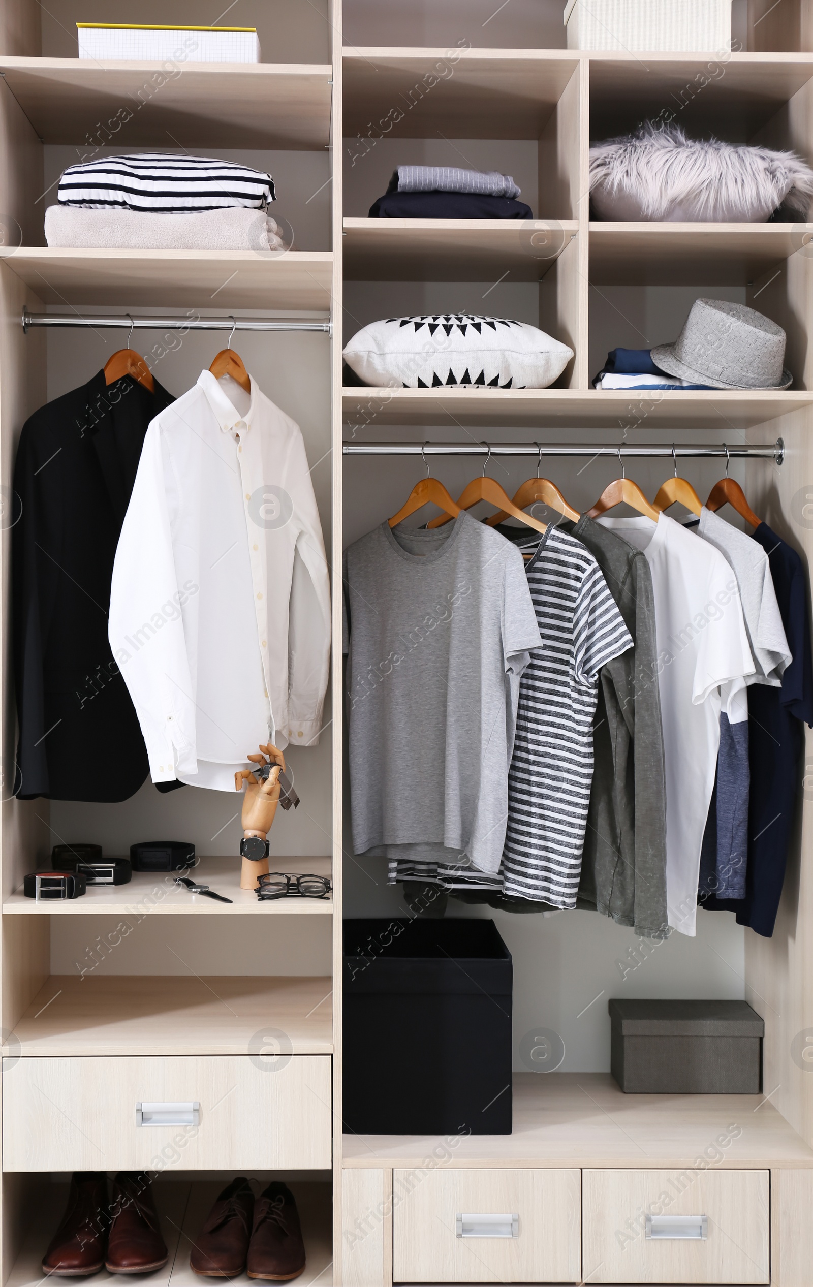 Photo of Stylish clothes, shoes and home stuff in large wardrobe closet