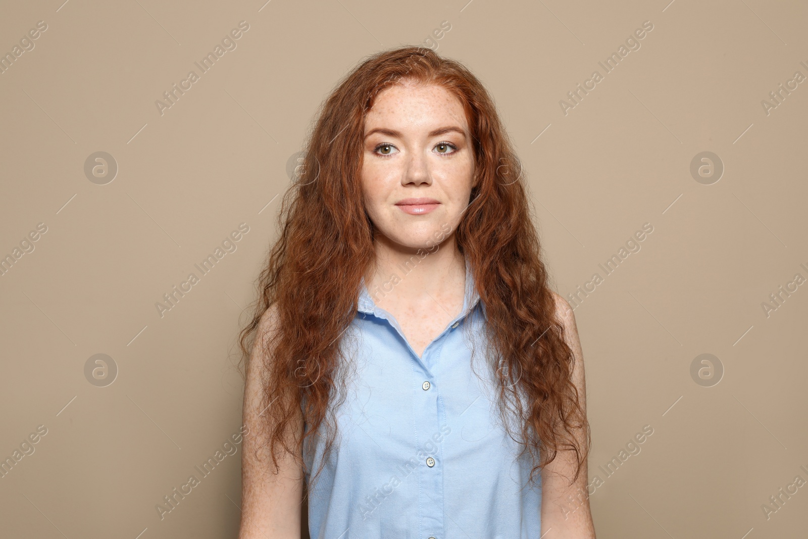 Photo of Portrait of young woman with beautiful face on beige background