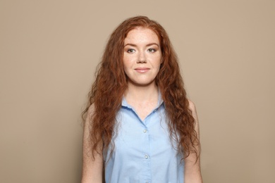 Portrait of young woman with beautiful face on beige background