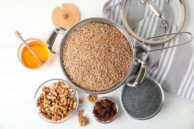 Ingredients for traditional kutia on white wooden table, flat lay