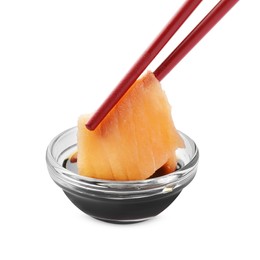 Photo of Dipping tasty salmon sashimi into soy sauce isolated on white