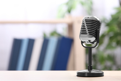 Photo of Retro microphone on table indoors, space for text. Interview