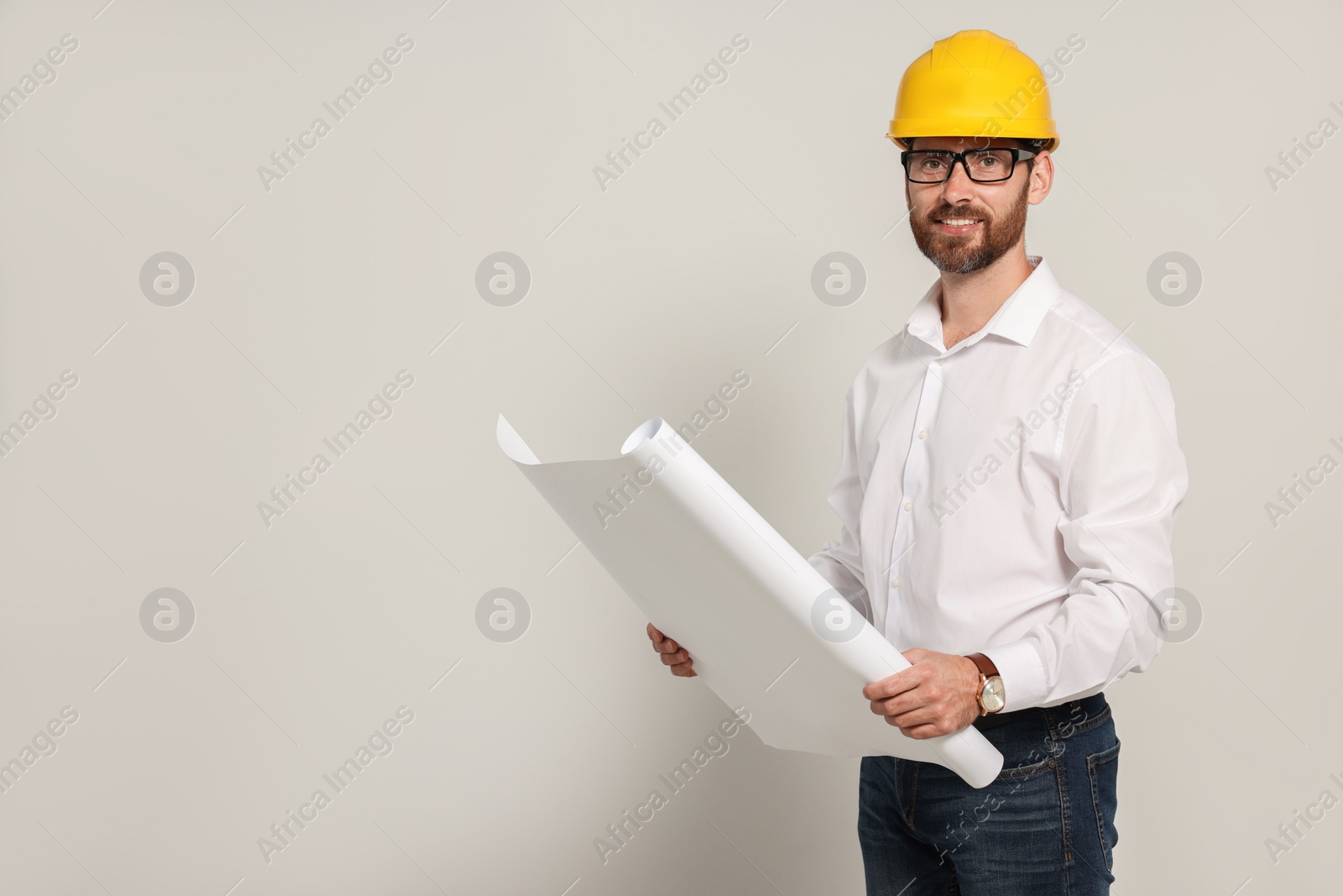 Photo of Professional engineer in hard hat with draft on white background, space for text
