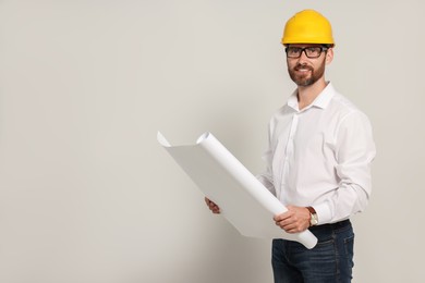 Professional engineer in hard hat with draft on white background, space for text