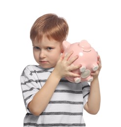 Photo of Cute little boy with ceramic piggy bank on white background