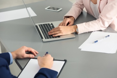 Human resources manager conducting job interview with applicant in office, closeup