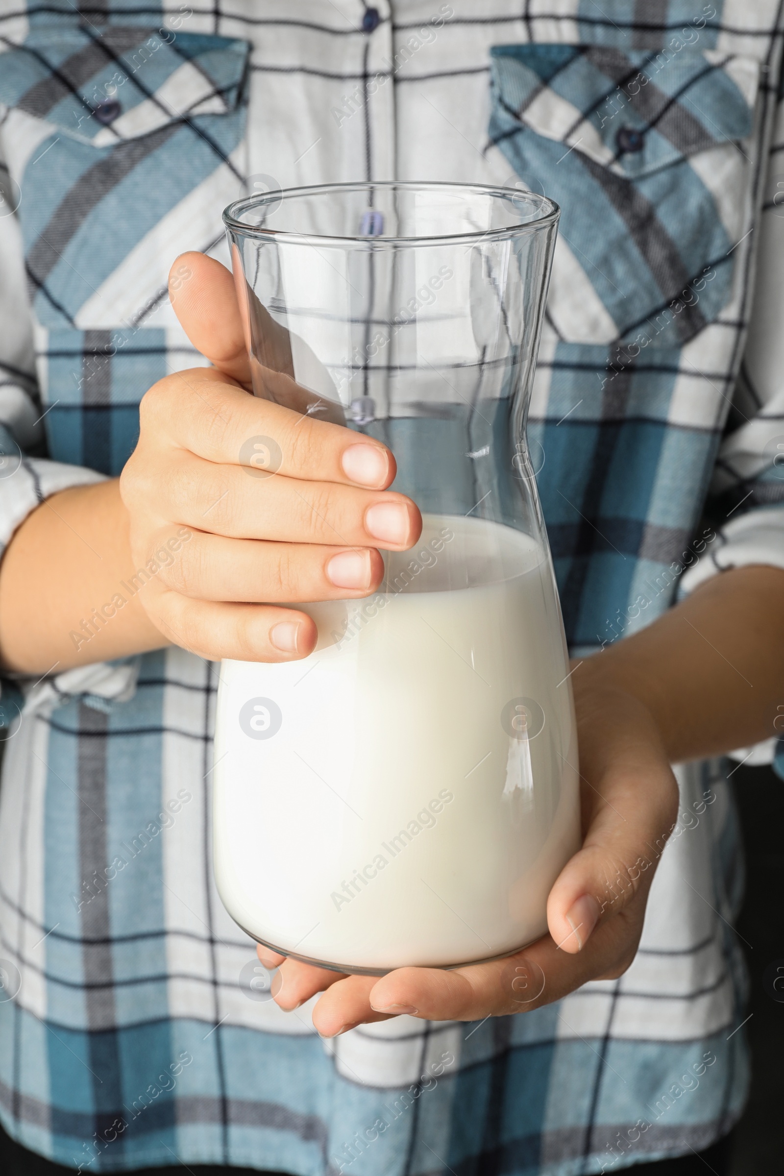Photo of Woman holding jug of hemp milk, closeup