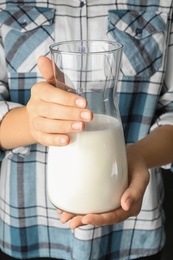 Woman holding jug of hemp milk, closeup