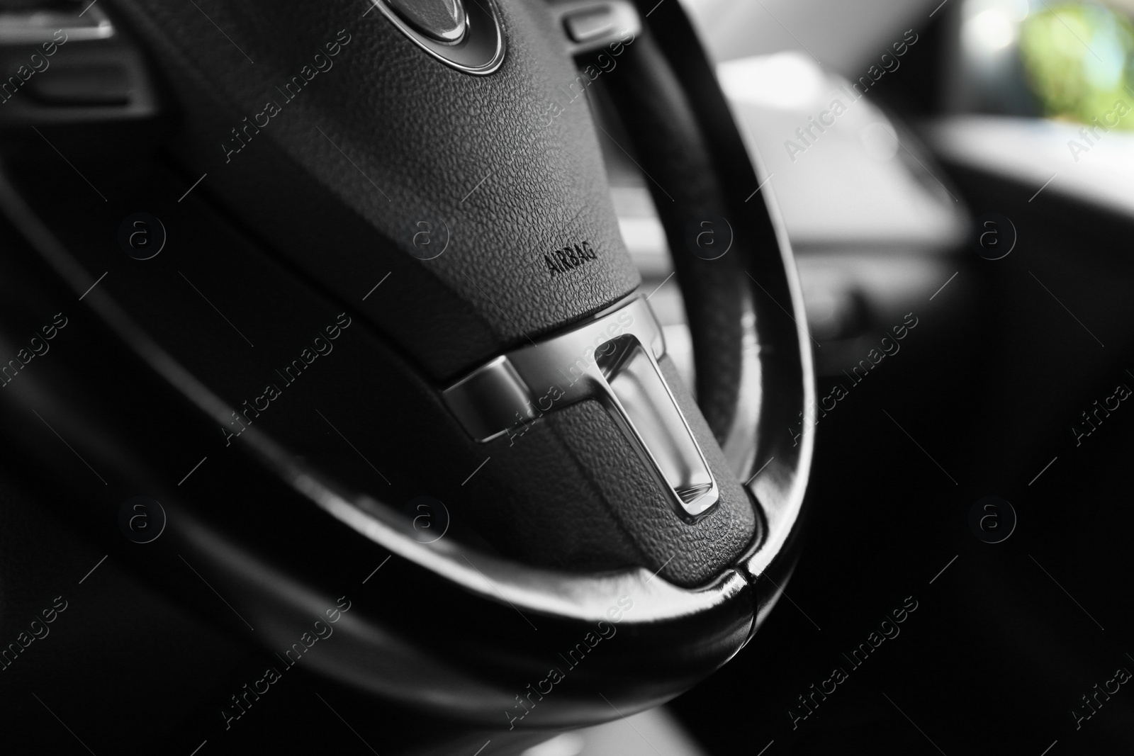 Photo of Safety airbag sign on steering wheel in car, closeup