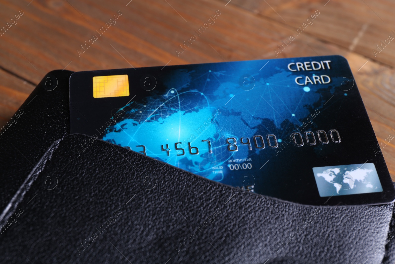 Photo of Credit card in leather wallet on table, closeup