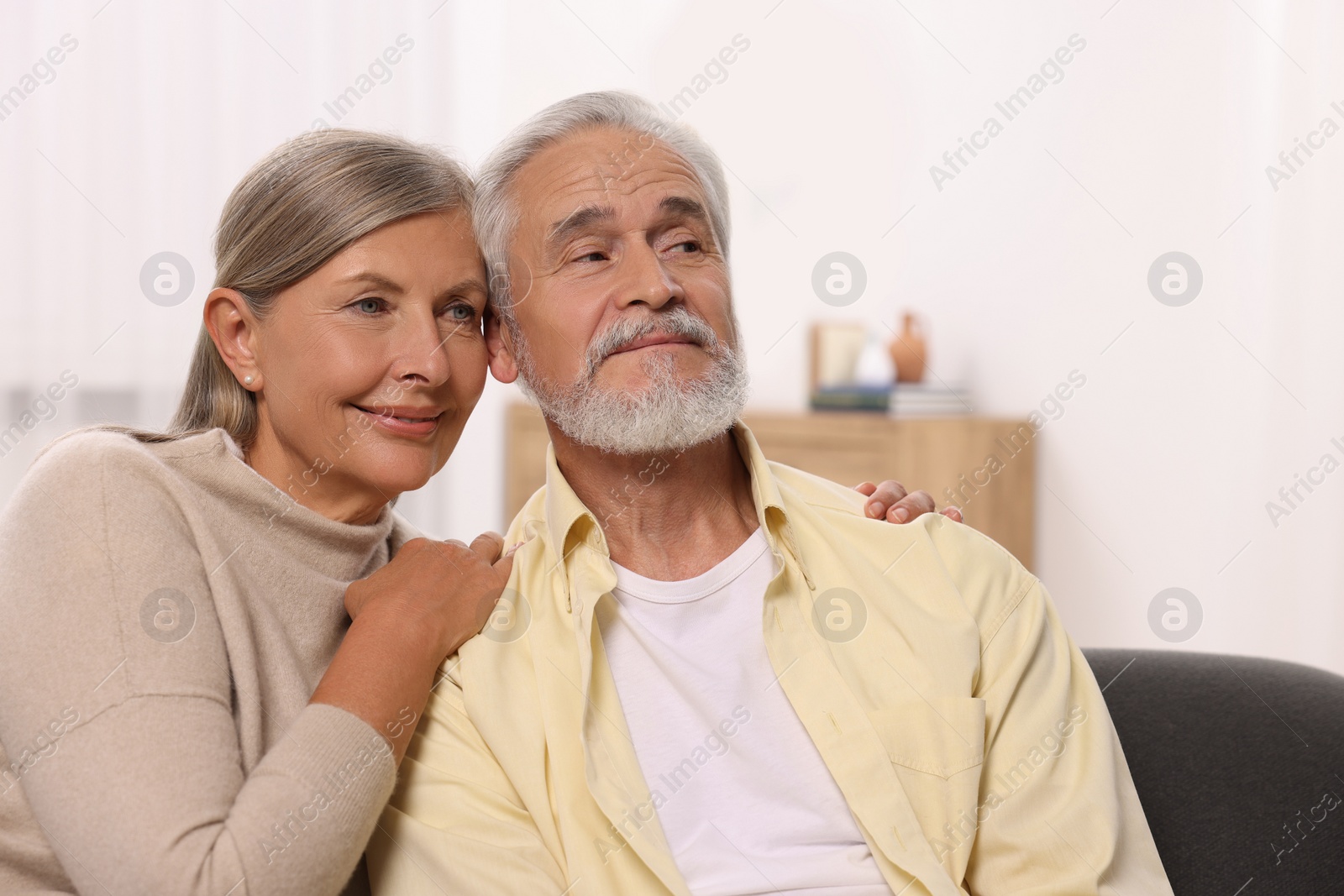 Photo of Portrait of affectionate senior couple at home, space for text