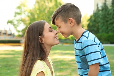 Mother with her cute child in green park on sunny day. Happy family