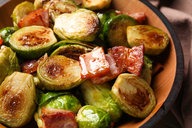 Delicious fried Brussels sprouts with bacon in bowl, closeup