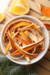 Dry peels, oranges and fir branch on table, flat lay