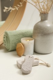 Pumice stones on white table in bathroom, space for text