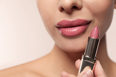 Photo of Woman with pink lipstick on light background, closeup