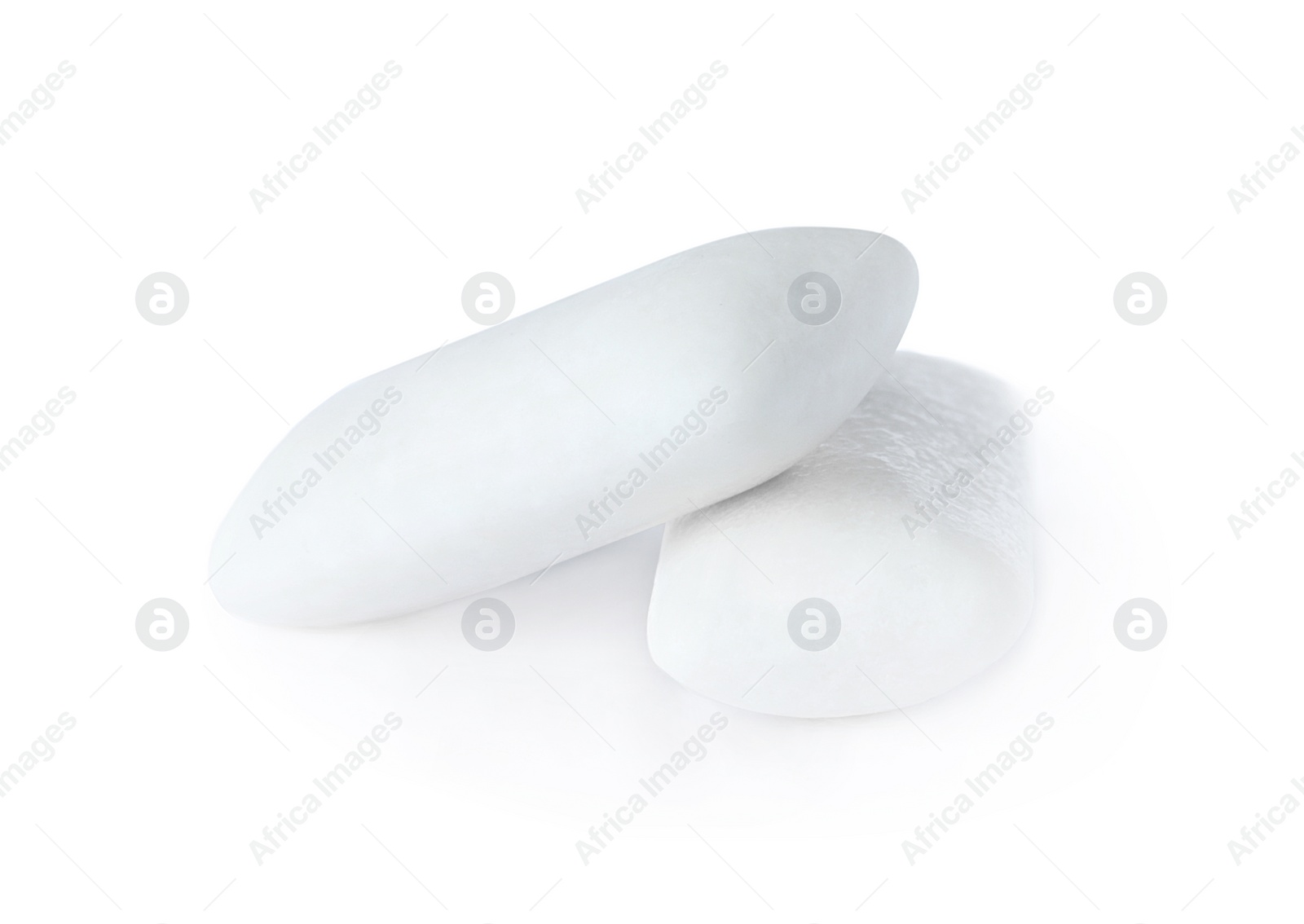 Photo of Two tasty chewing gums on white background