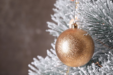 Photo of Beautiful Christmas tree with festive decor on brown background, closeup. Space for text