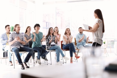 Photo of Female business trainer giving lecture in office