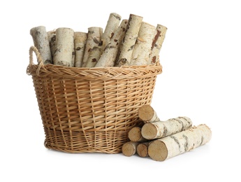 Wicker basket with firewood on white background