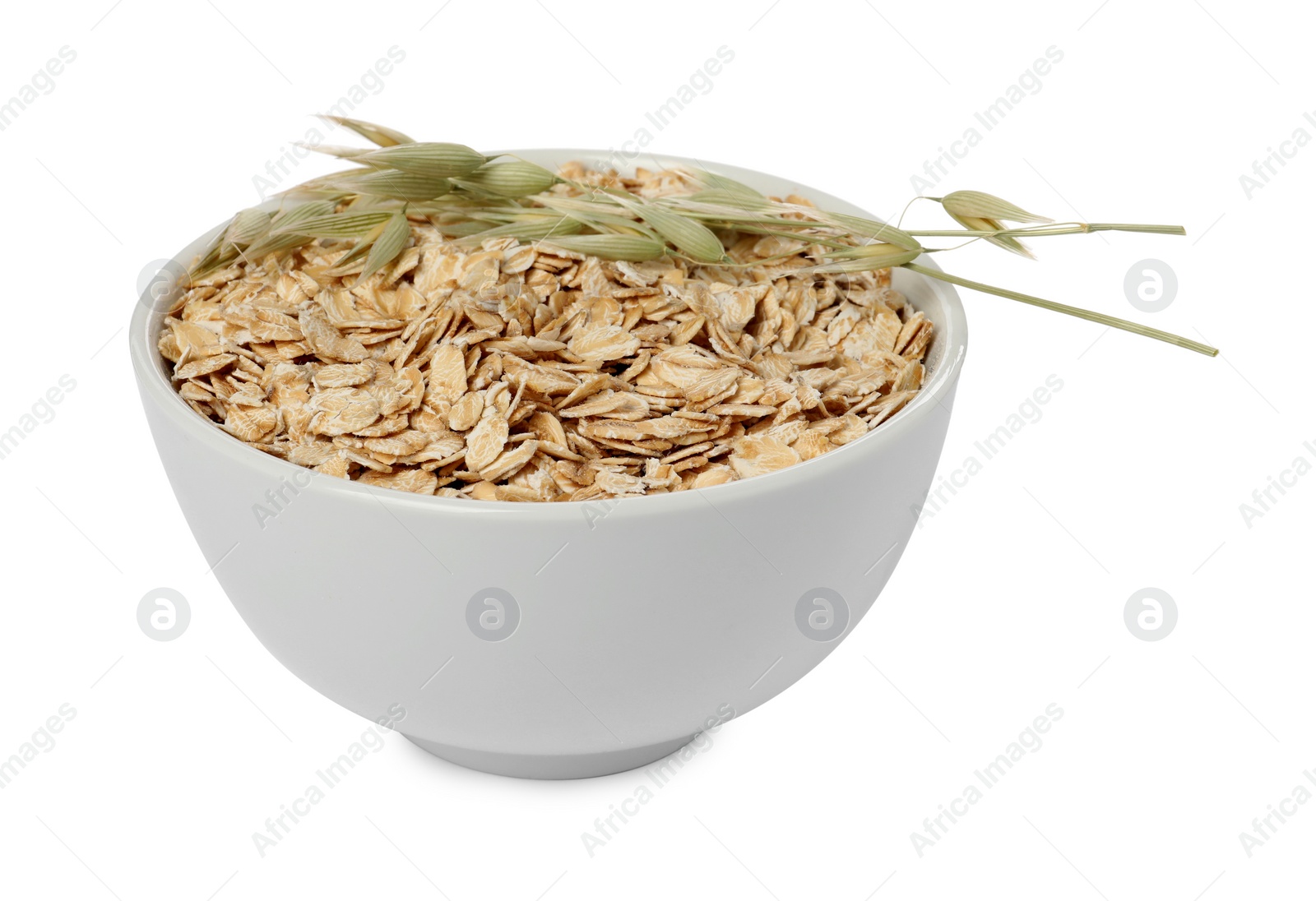 Photo of Bowl of oatmeal and branches with florets isolated on white