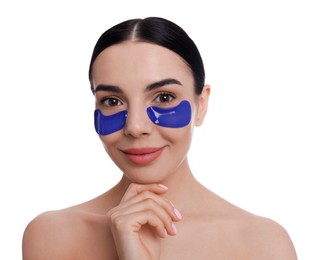 Beautiful young woman with under eye patches on white background